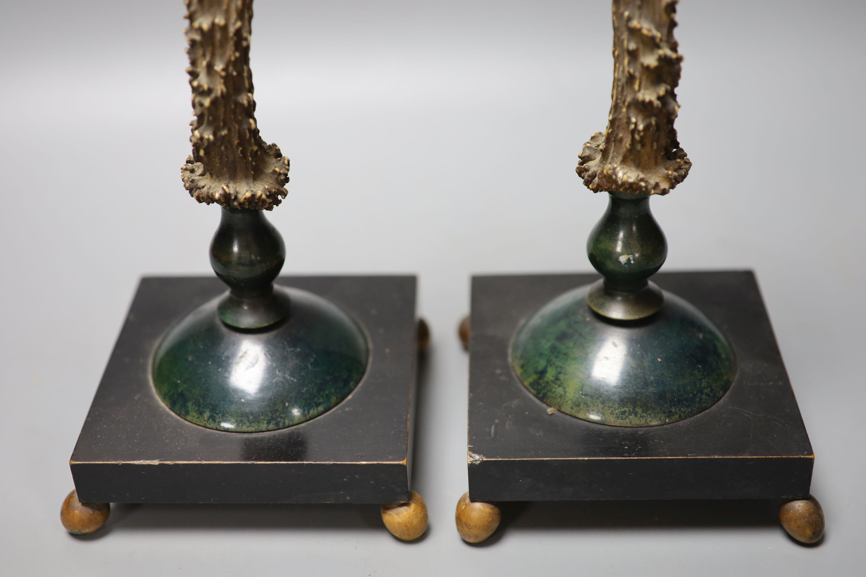A pair of late 19th/early 20th century antler candlesticks, 34.5cm